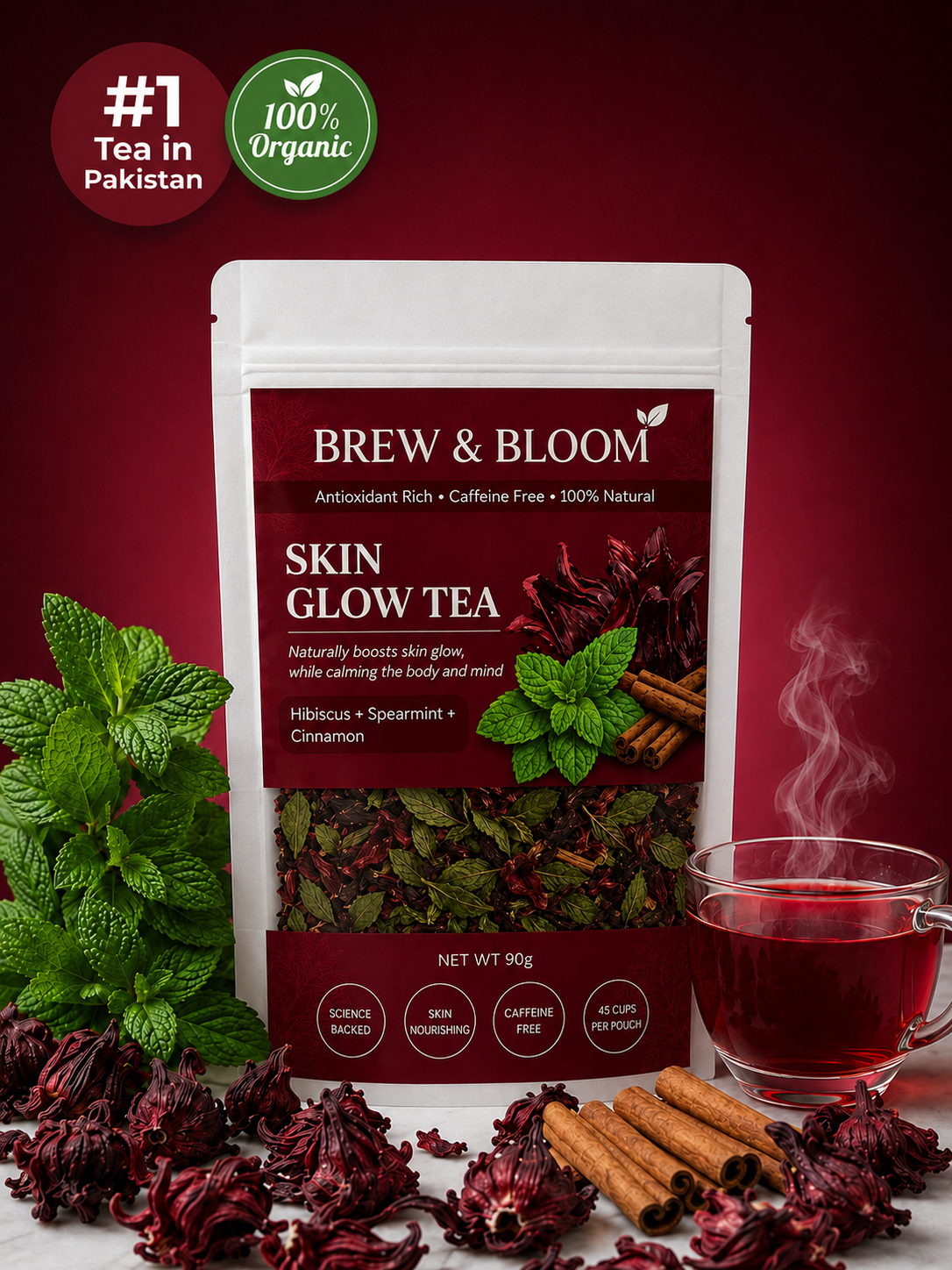 A 90g stand-up pouch of Brew & Bloom Skin Glow Tea displayed on a white surface with a glass of brewed tea, loose dried hibiscus, cinnamon sticks, and fresh mint leaves against a dark red background. Promotional badges in the top left read '#1 Tea in Pakistan' and '100% Organic'.